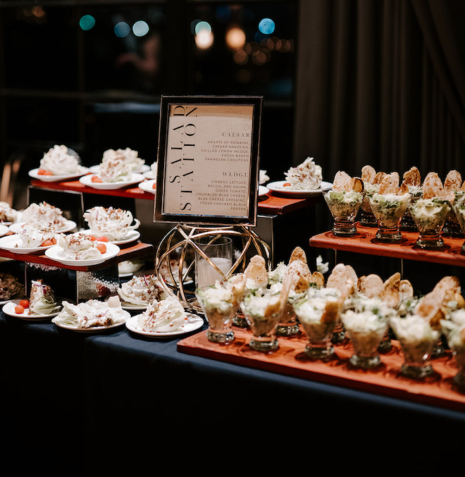 The salad station with single servings of caesar and wedge salads. 