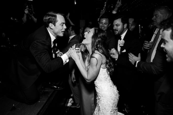 The groom holding a microphone for the bride as she sings during the reception.