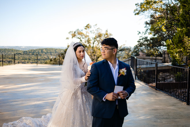 The bride tapping on the groom's shoulder during their first look.