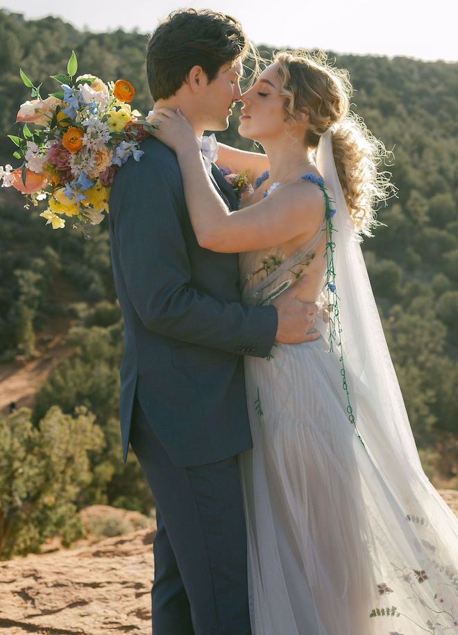 The bride and groom about to kiss on top of a mountain in Sedona, Arizona.