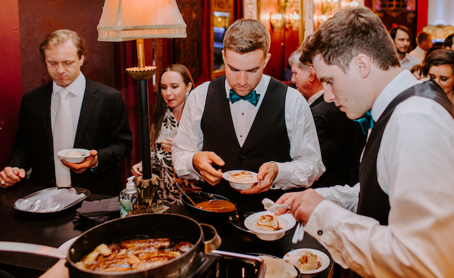 Wedding guests indulge in a dessert station serving ice creams and other sweet treats catered by Bailey Connor Catering. 