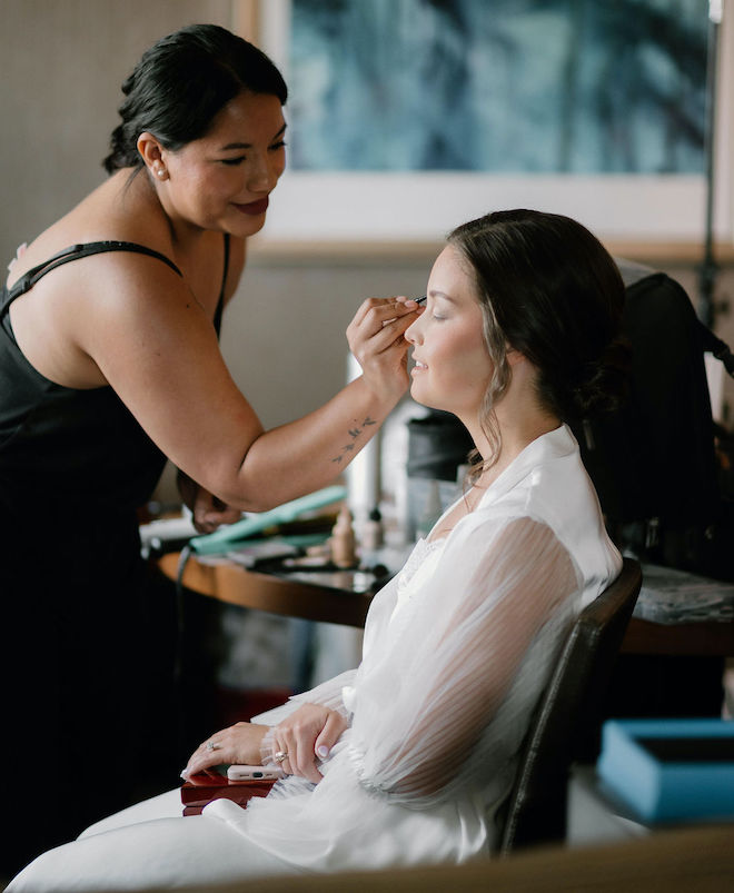 Lilly Bridal Artistry putting eyeshadow on the bride. 