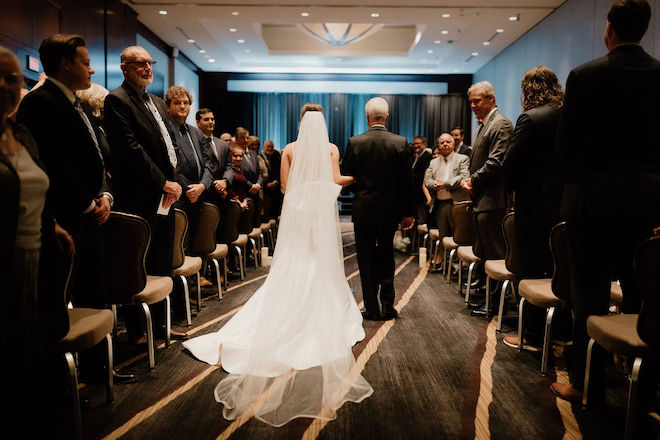 The bride and her father walking down the aisle.