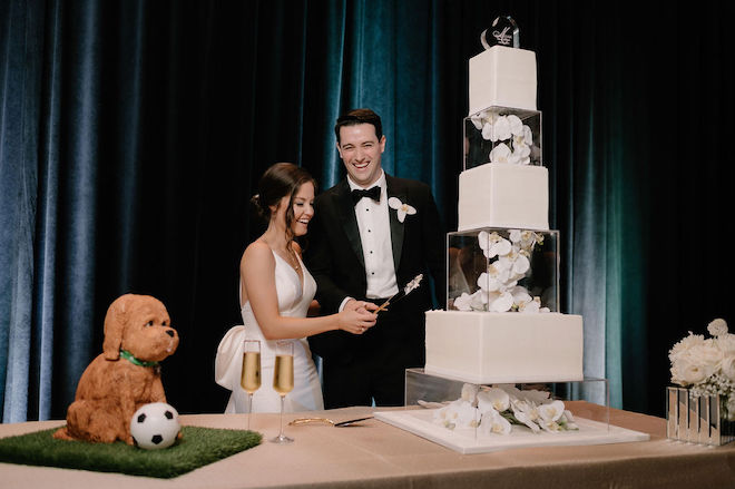 The bride and groom cutting their wedding cake.