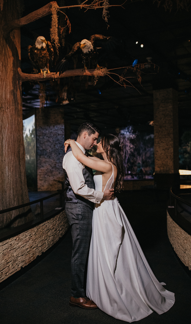 The bride and groom gaze into each others eyes at one of the exhibits at the Houston Museum of Natural Science. 