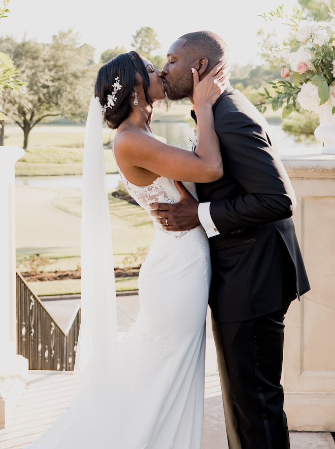 The bride and groom share a kiss after exchanging vows.