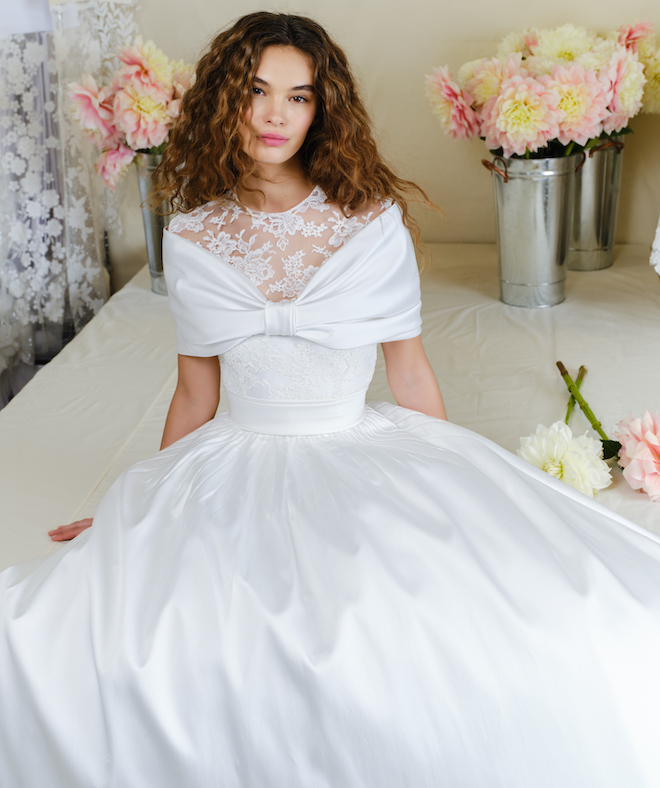 A gown with a satin bow across the bodice by Reem Acra. 