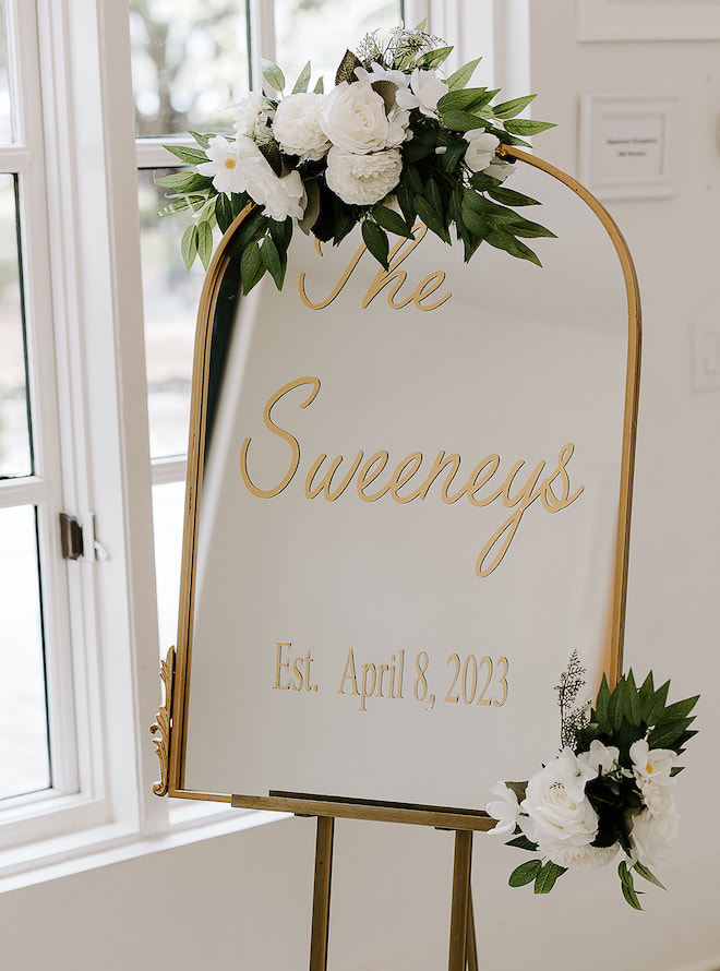 A gold mirror with "The Sweeneys Est. April 8, 2023" in gold lettering. 