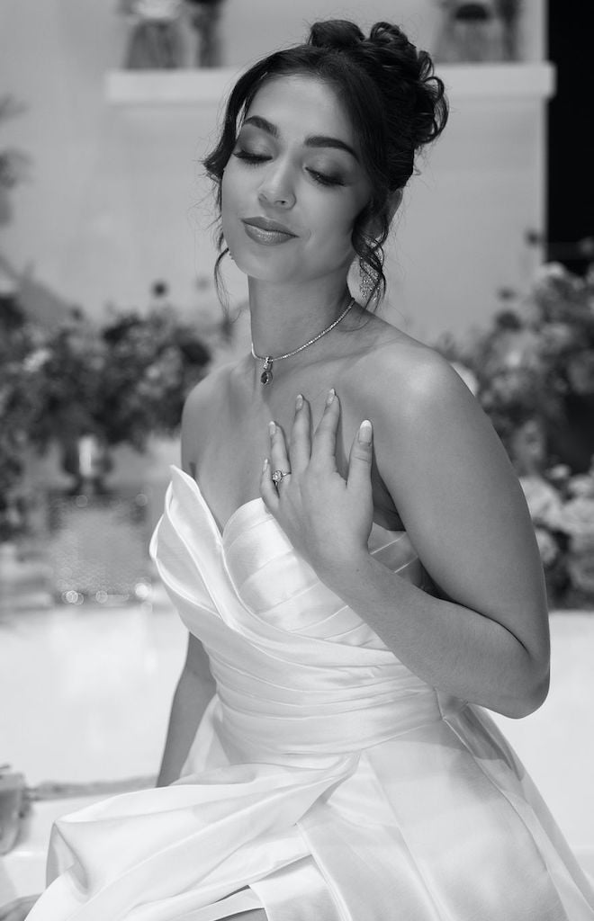 The bride smiles for the camera as she shows off her fine jewelry from Shaftel Diamonds. 