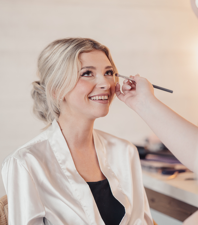 The bride gets her makeup done for the autumn wedding editorial at Hummingbird Hill.