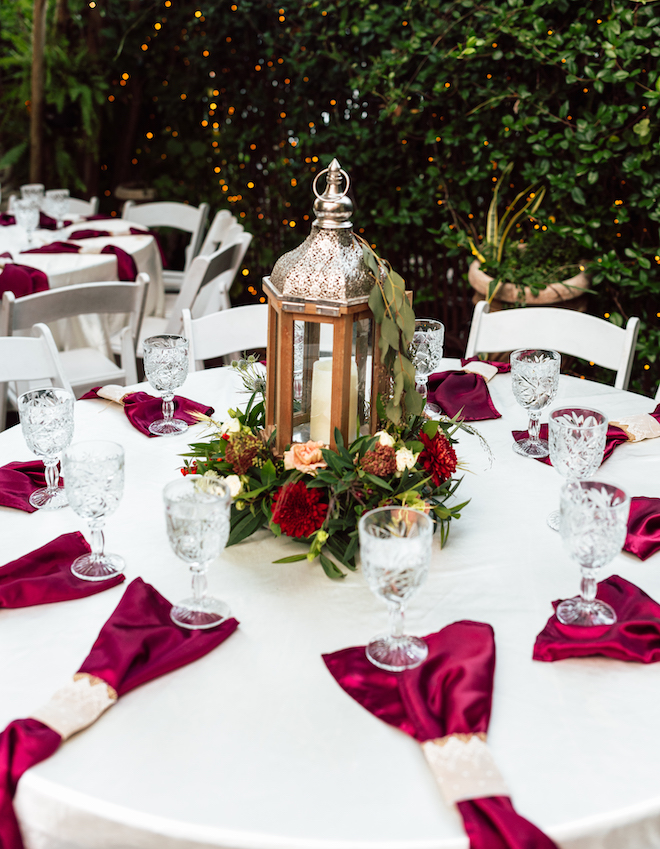 Burgundy colored napkins detail the reception tables.