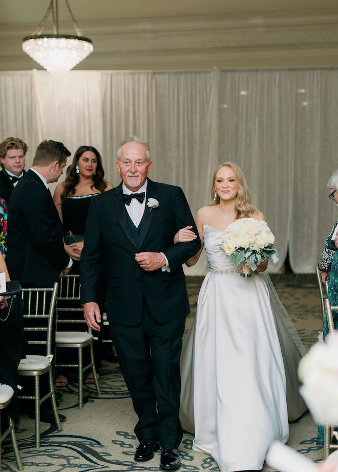 The bride and her father walking down the aisle.