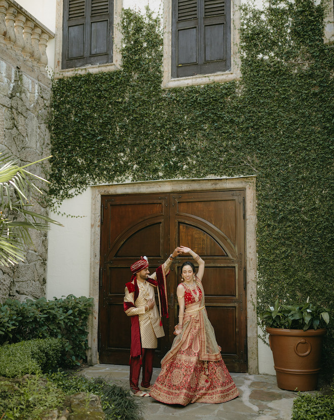 The groom spins his bride outside their wedding venue, Bell Tower on 34th.