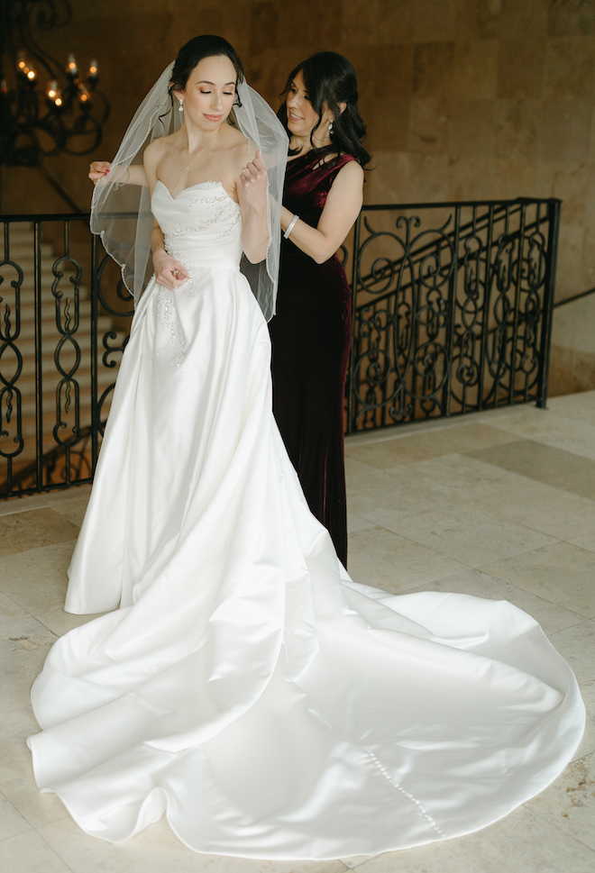 The bride's mom helps her with her veil before her traditional ceremony at the Bell Tower on 34th. 