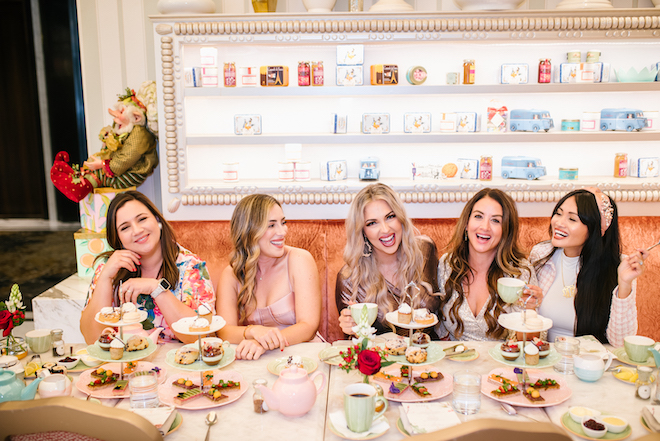 Five woman at a tea party at The Post Oak at Uptown Houston's on-site restaurant, Bloom and Bee.