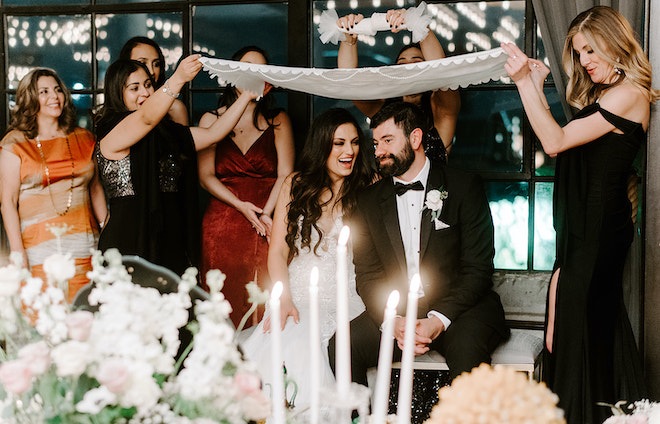 The bride and groom enjoy fun celebrations at their wedding day at the Houston wedding venue, The Astorian. 