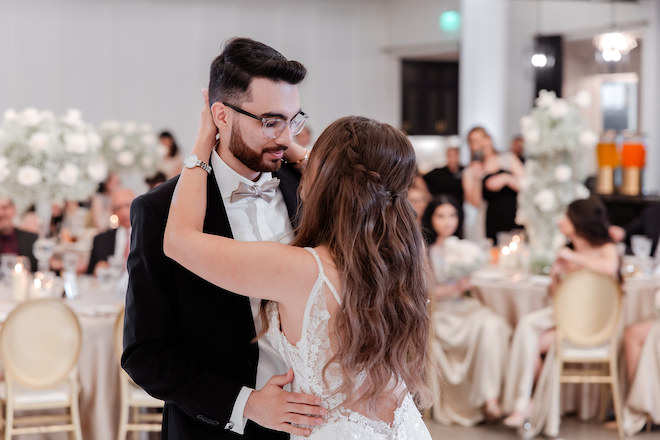 The bride and groom dance at their wedding reception. 