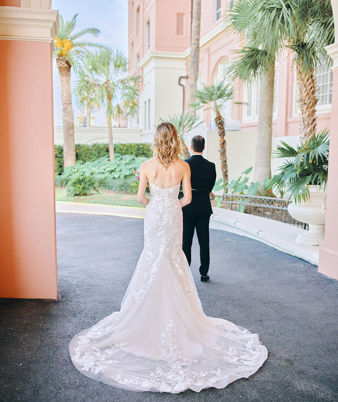 The bride standing behind the groom at the Grand Galvez.