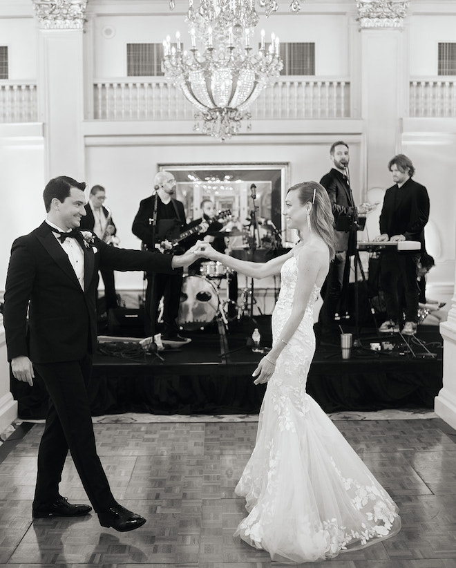 The bride and groom dancing in front of the band. 