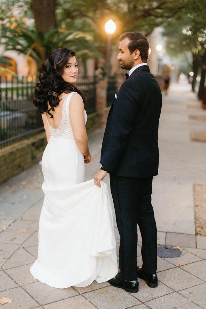 The bride and groom walk around Downtown Houston before their wedding reception at the Crystal Ballroom at the Rice.