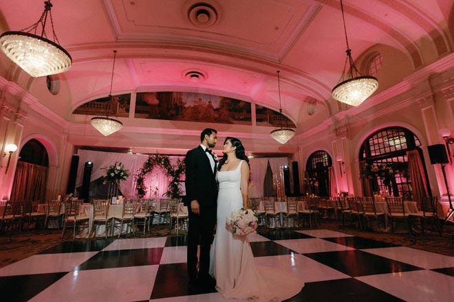 The bride and groom look into each others eyes on the dance floor at their Houston wedding reception.