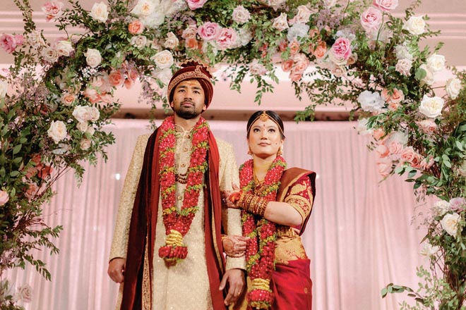 The bride and groom exit their Hindu ceremony at in the ballroom at The Crystal Ballroom at the Rice.