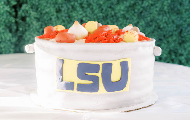 The groom's cake is shaped into a pot decorated with crawfish, potatoes, onions and the LSU logo.