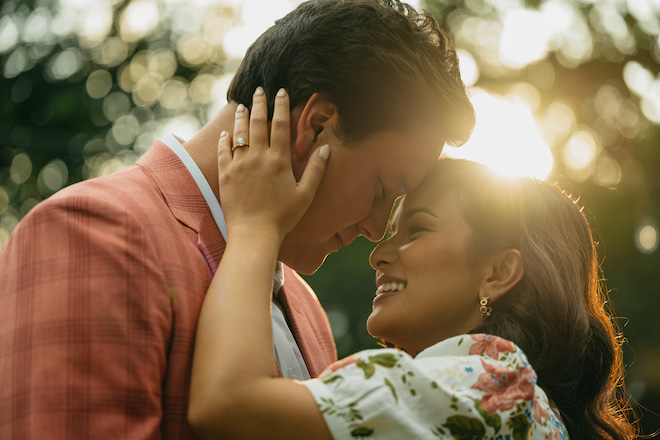 Natalie Hee and her husband smiling at each other, about to kiss.