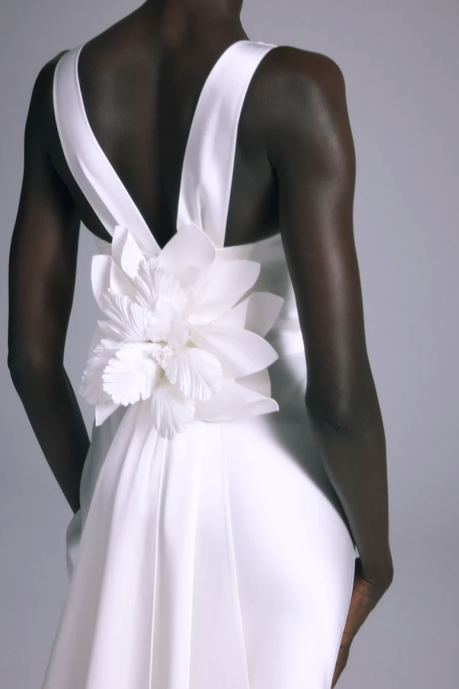 A flower detail on the back of a wedding gown. 