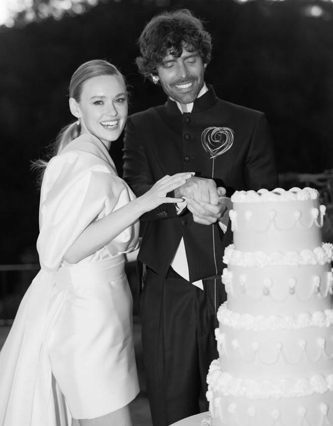 The bride and groom cutting their vintage-style wedding cake. 