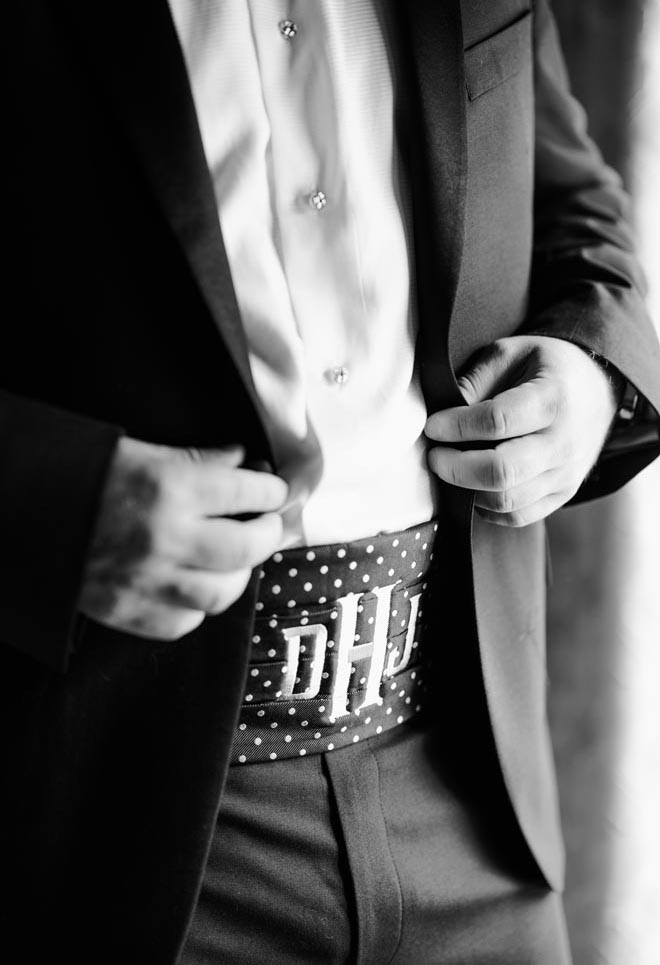 The groom wearing a monogrammed polka dot cummerbund. 