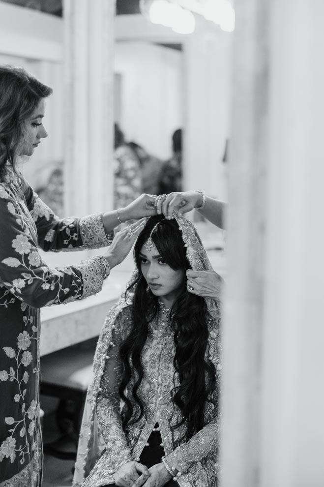 The bride changes into traditional Bengali wedding attire for the reception.