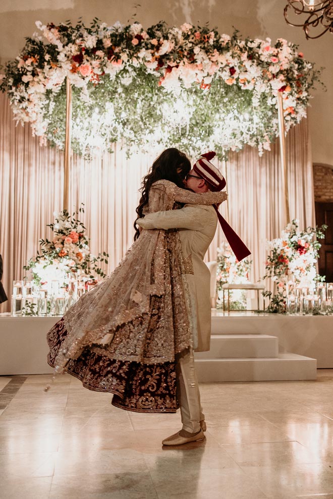 The bride and groom perform their choreographed first dance at their wedding reception. 