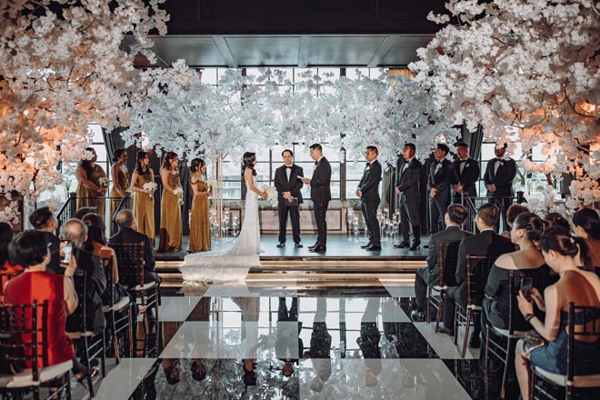 The bride and groom exchange vows at the alter at Downtown Houston wedding venue, The Astorian.