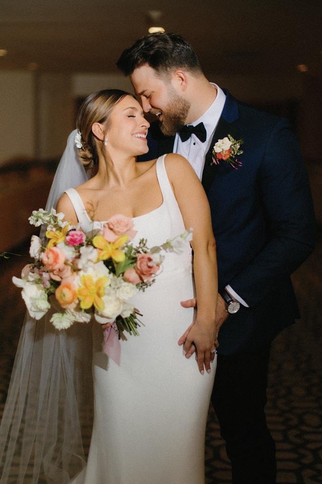 The bride and groom share an intimate moment at their colorful springtime garden wedding at the Omni Houston Hotel.