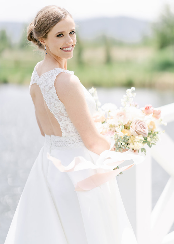 The bride smiling holding her bouquet outside in Park City, Utah.