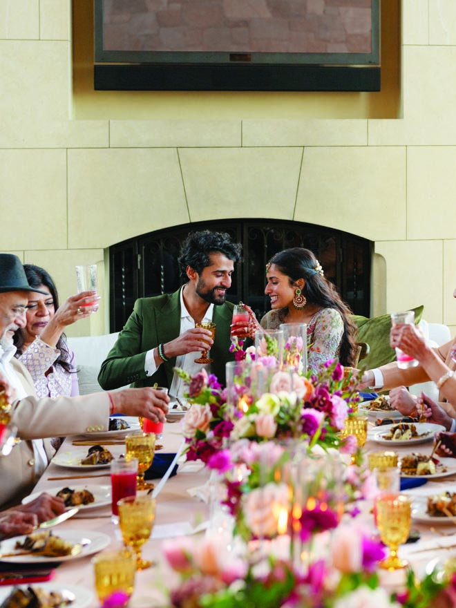 The bride and groom cheers with a toast at their nikkah ceremony with friends and family. 