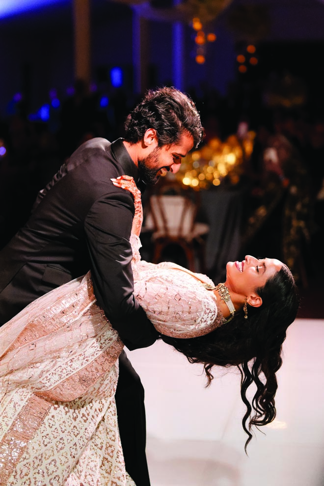 The groom dips the bride at their Malibu wedding reception.