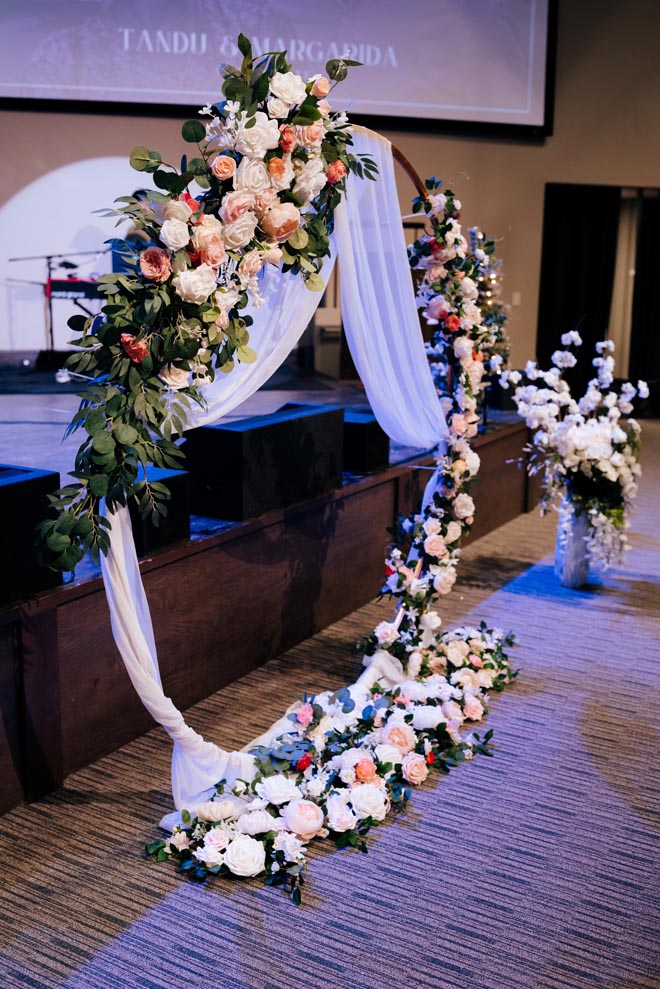 Pink and white roses detail the floral instillation for the Houston wedding ceremony.