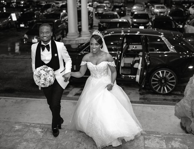 The bride and groom enter their intimate ballroom wedding reception in Houston.