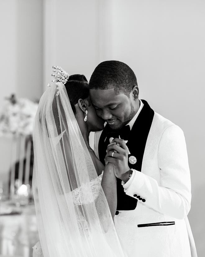 The bride and groom share a first dance at their intimate ballroom wedding in Houston.