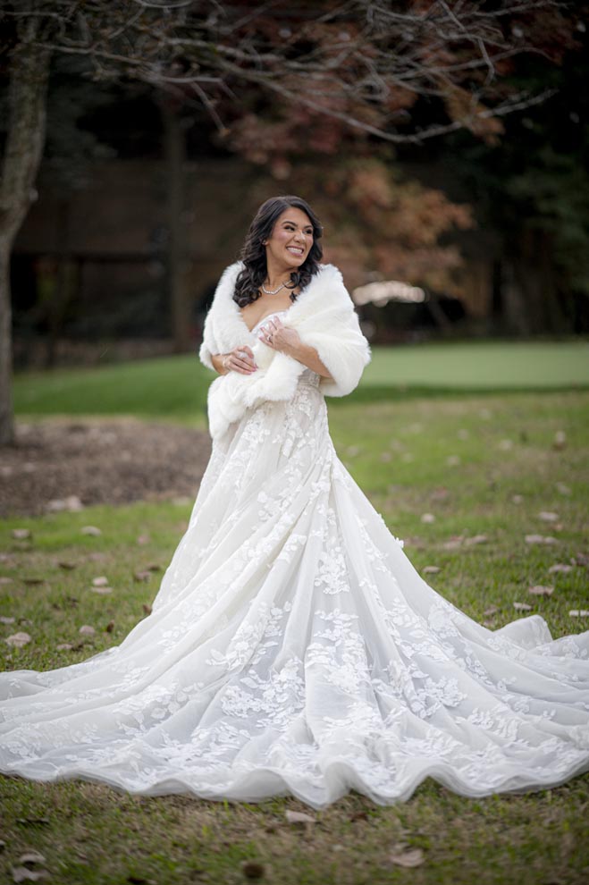 The bride looks over her shoulder and smiles. 