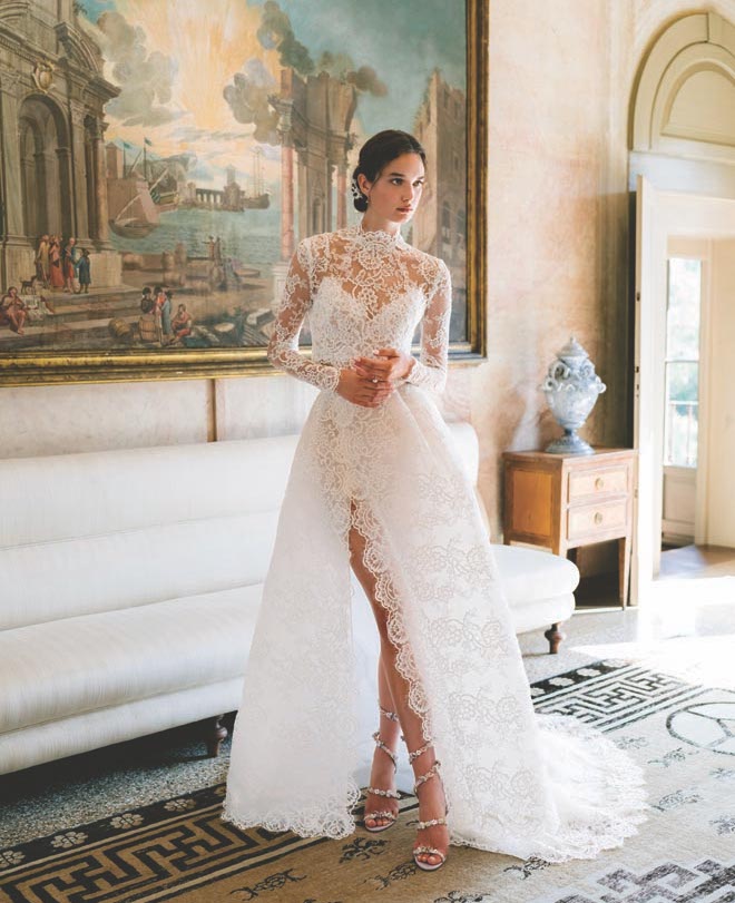 The bride models a lace wedding down designed by Monique Lhuillier. 