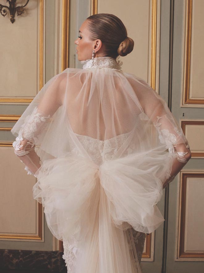 The bride models an ivory tulle wedding bow designed by Galia Lahav. 