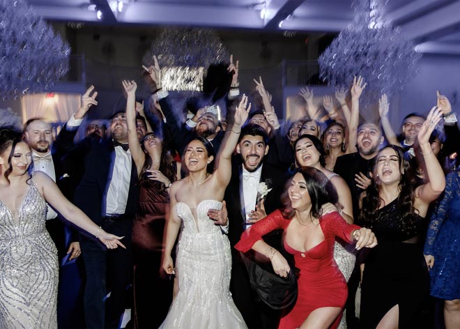 The couple dance on the dance floor with their wedding guests. 