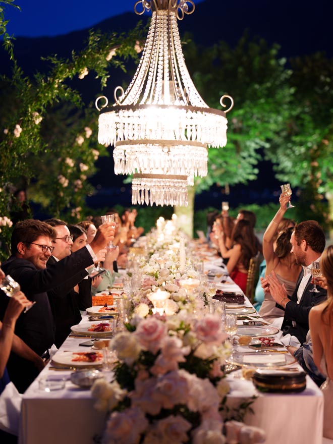 Wedding guests raise their glasses for a toast on Lake Como, Italy.