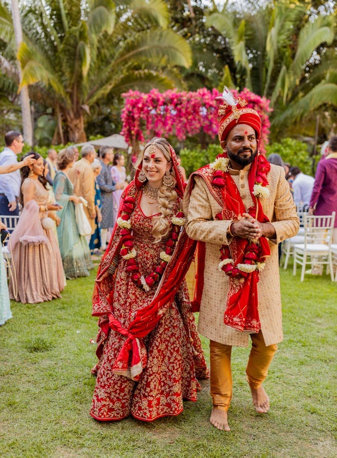 The bride and groom walk down the aisle after their Hindu ceremony. 