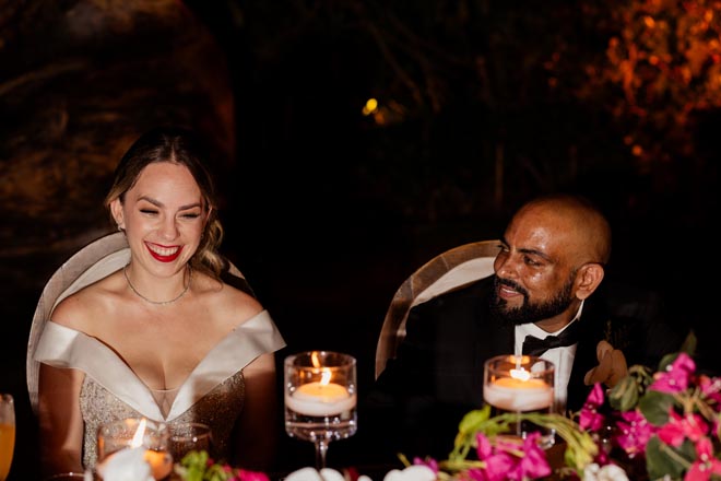 The bride and groom laugh at their wedding reception in Puerto Vallarta, Mexico.