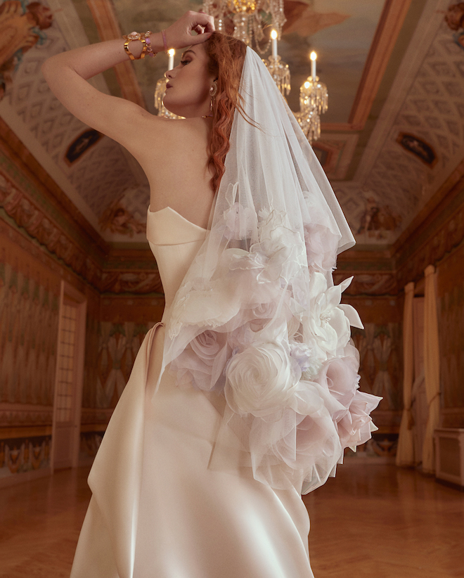 A short veil with floral embellishments in subtle pastel colors. 