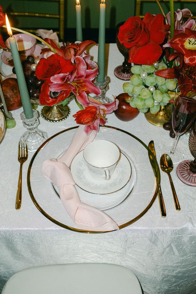 Red florals decorate the table at the vintage bridal shower.